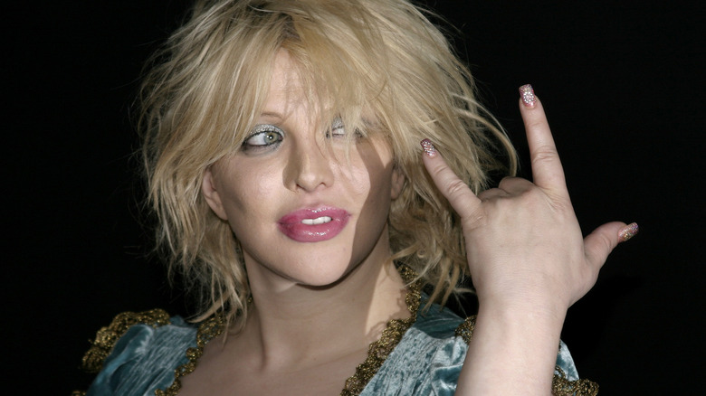 Courtney Love rock and roll sign 