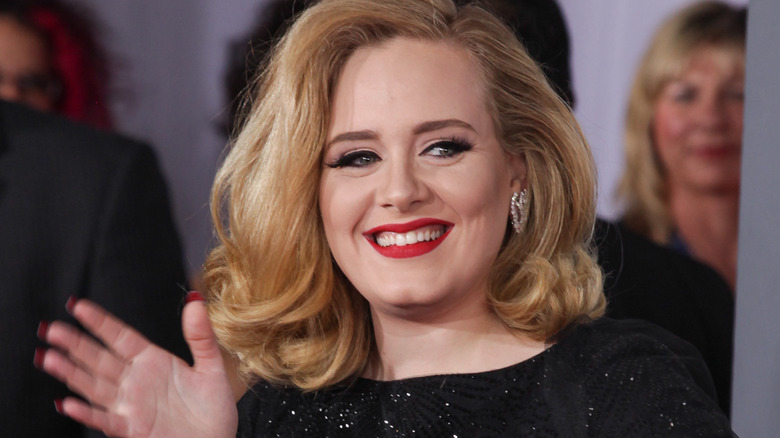 Adele smiling and waving