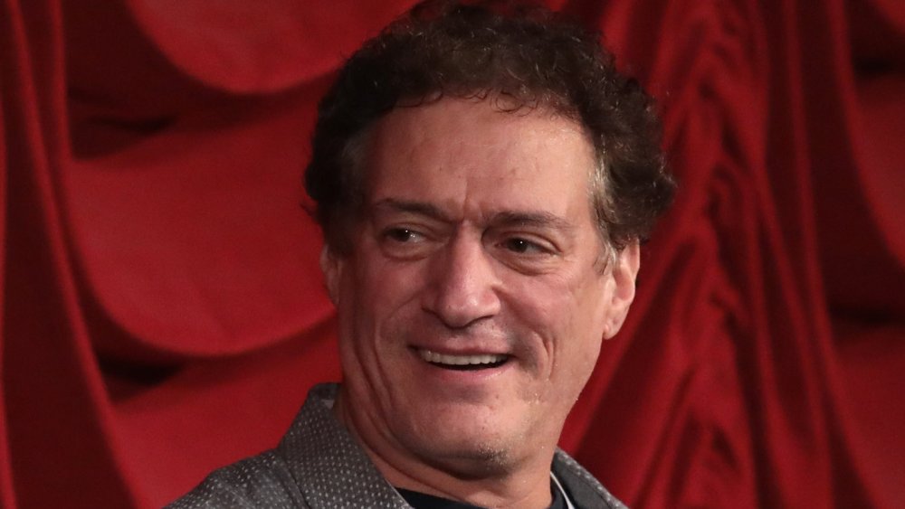 Anthony Cumia looking to the left and smirking