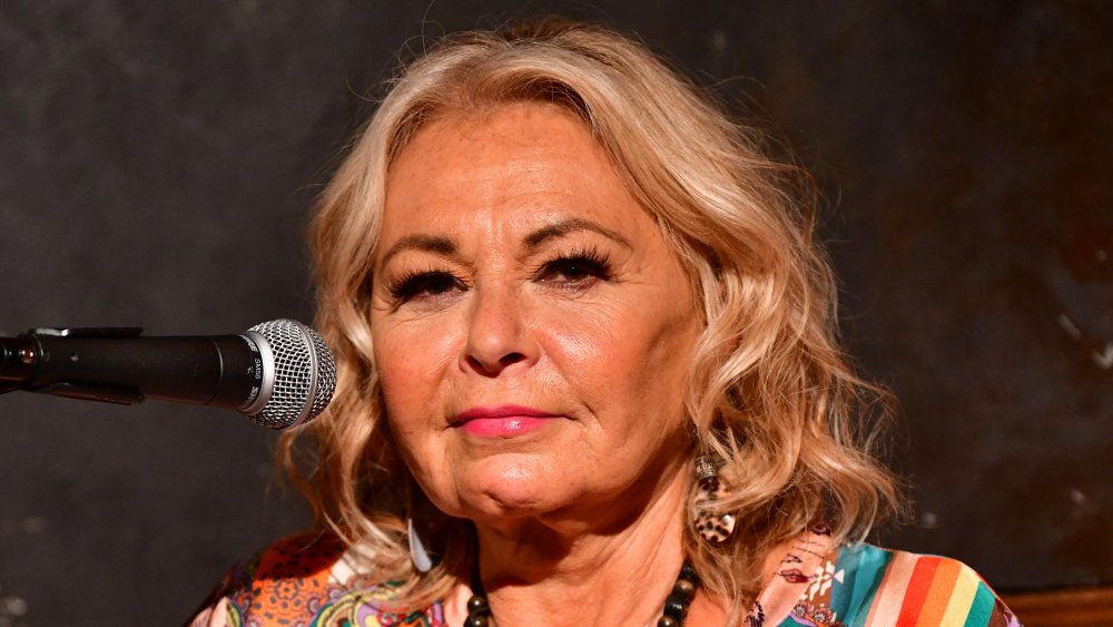 Roseanne Barr with microphone in front of her