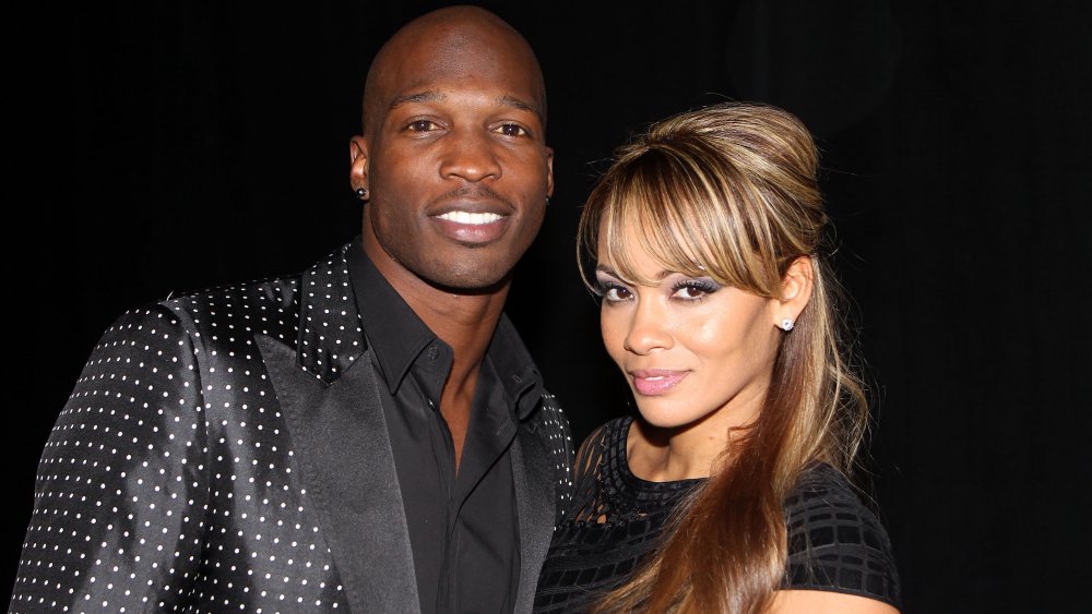 Chad "Ochocinco" Johnson standing beside Evelyn Lozada smiling