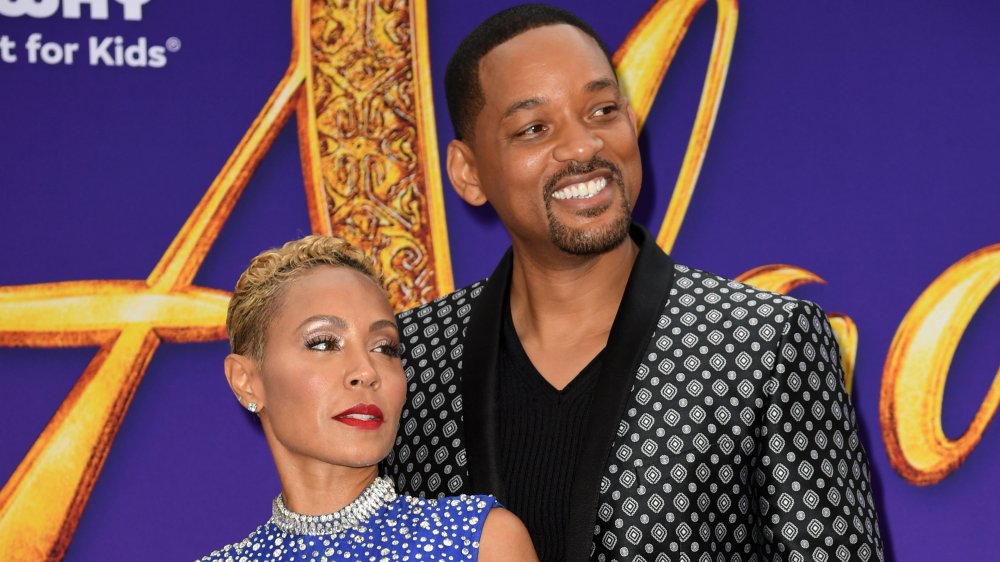 Jada Pinkett Smith and Will Smith posing alongside each other on the red carpet