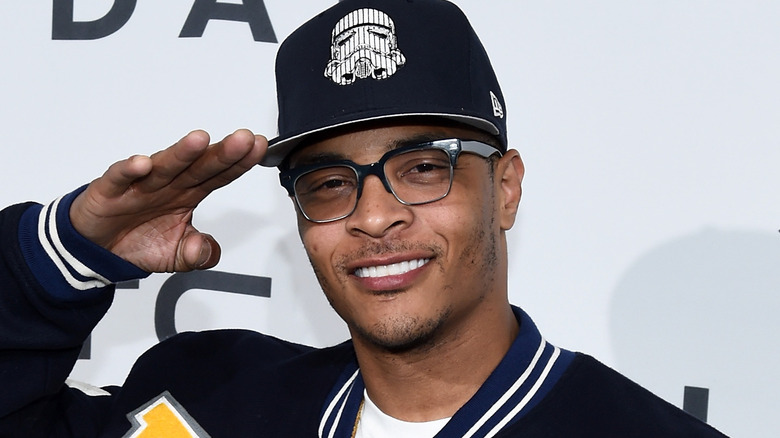 T.I. giving a salute and smiling