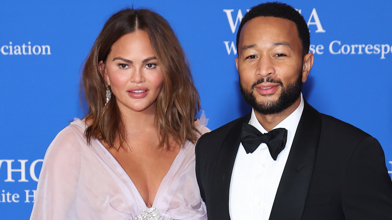 Chrissy Teigen posing with John Legend