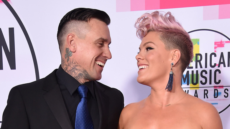 Pink and Carey Hart looking at each other lovingly