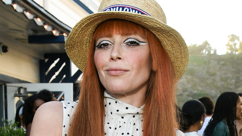 Natasha Lyonne wearing a hat and smiling