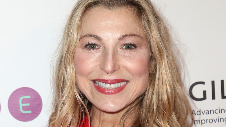 Tatum O'Neal smiling in red dress