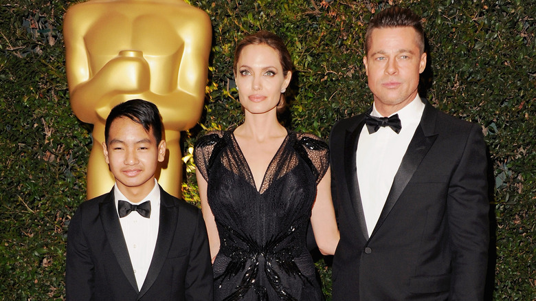 Maddox, Angelina Jolie, and Brad Pitt posing
