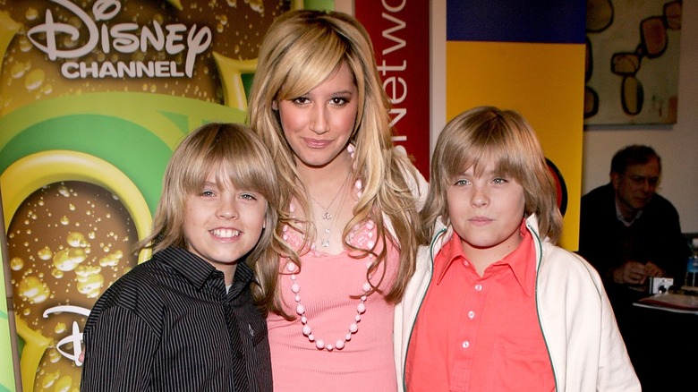 Ashley Tisdale posing with Sprouse twins