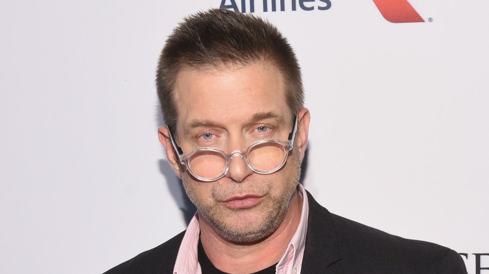 Stephen Baldwin wearing glasses on the lower bridge of nose, pursing his lips with a serious expression