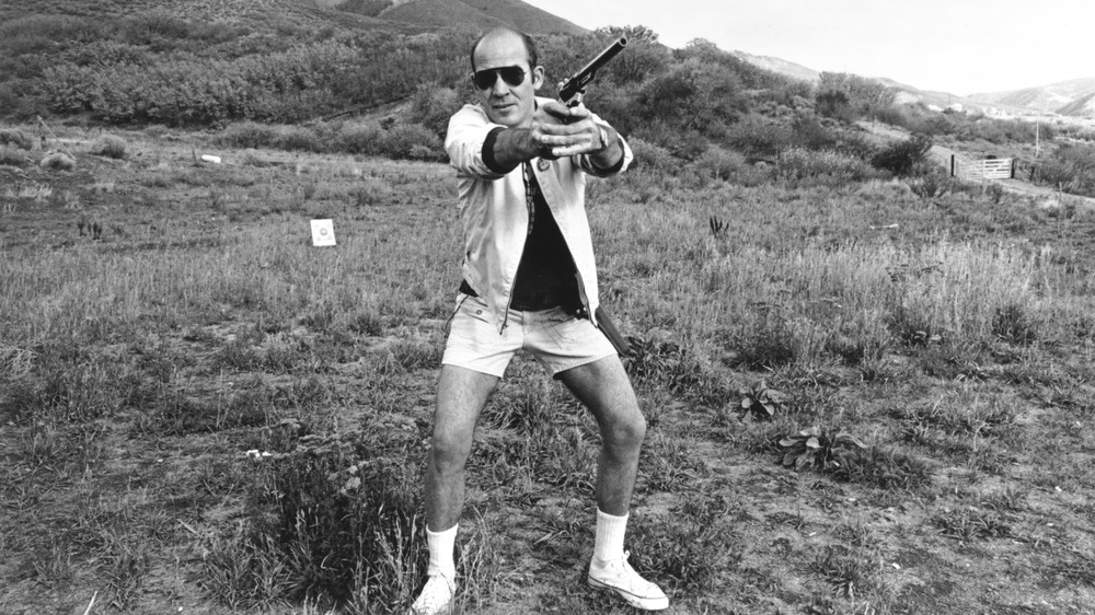 Hunter S. Thompson holding a gun 