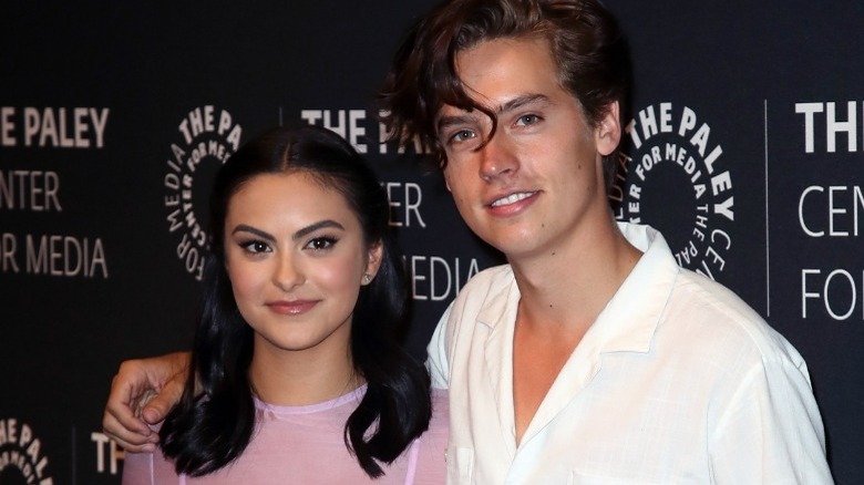 Camila Mendes and Cole Sprouse smiling at camera