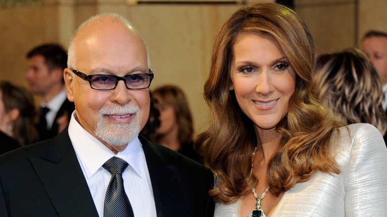 Rene Angelil and Celine Dion posing at an event