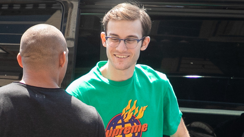 Rene-Charles Angelil shaking a man's hand and smiling