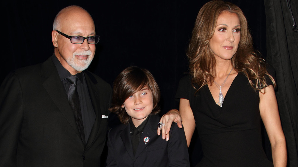 Celine Dion, René Angélil, and René-Charles Angélil posing together at an event