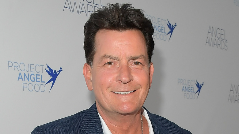 Charlie Sheen smiling on the red carpet 