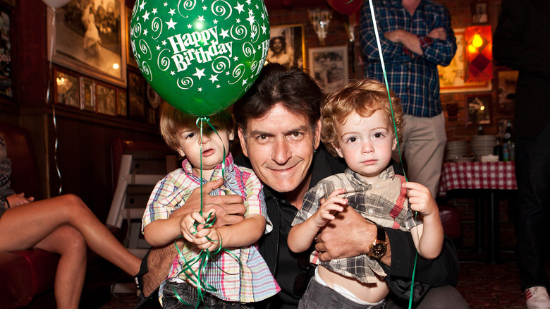 Max, Bob, and Charlie Sheen holding balloons