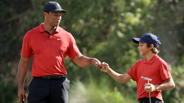 Tiger Woods bumping fists with Charlie Woods