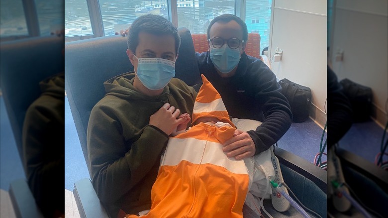 Pete and Chasten Buttigieg hold baby Gus in hospital on Halloween 2021