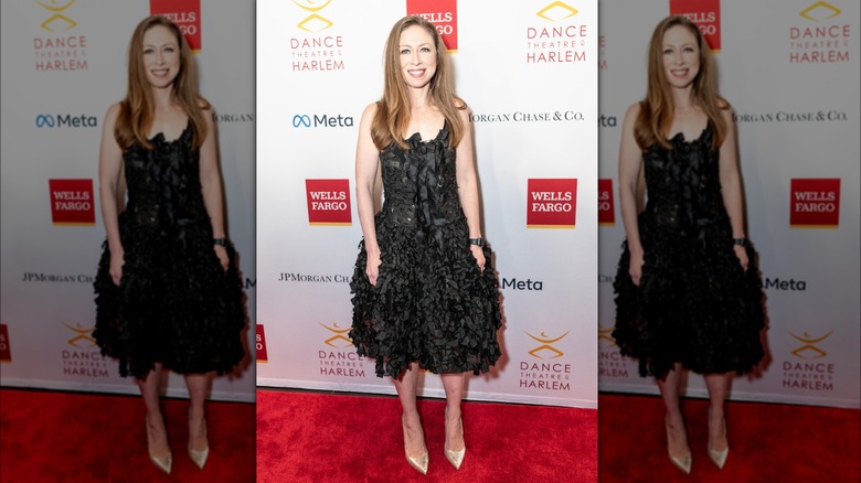 Chelsea Clinton black dress gold shoes