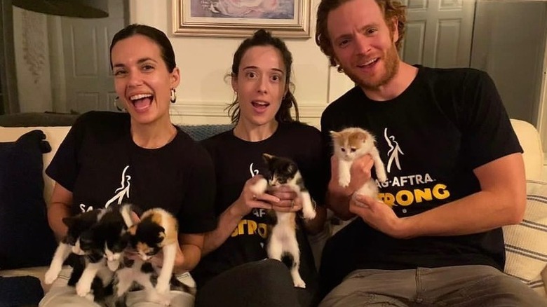 Nick Gehlfuss and Torrey DeVitto holding kittens