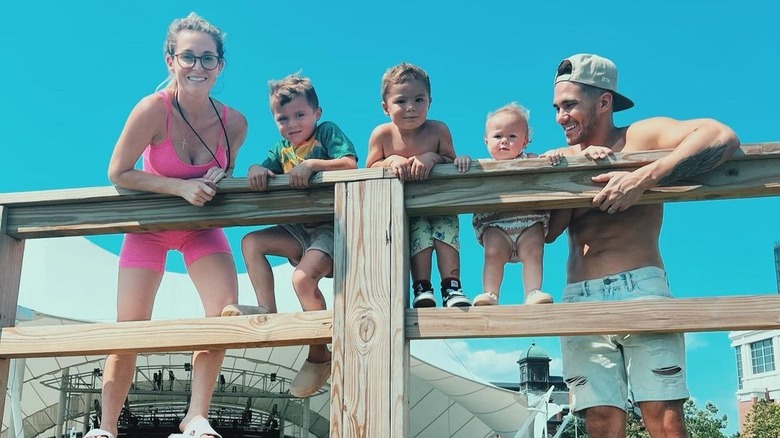 The PenaVega family posing on fence