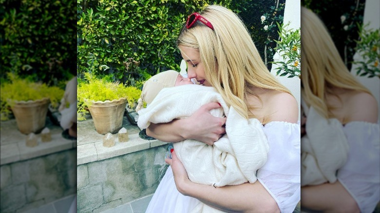 Emma Roberts cradling her son