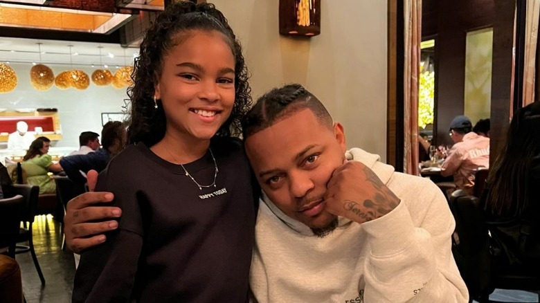 Shad Moss with arm around daughter 