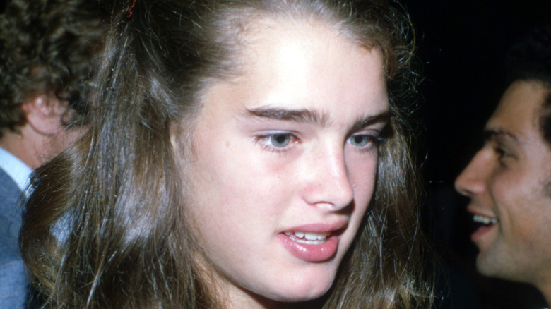 Young Brooke Shields looking down