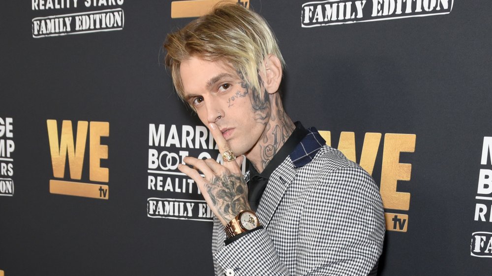 Aaron Carter poses with sign