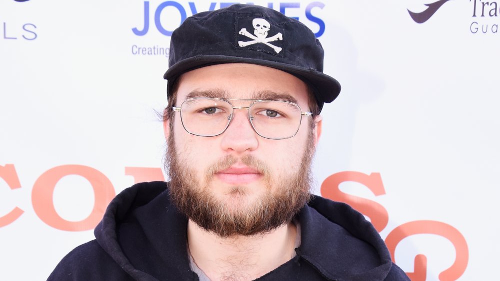 Angus T. Jones looking solemn 