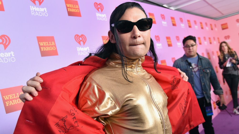 Corey Feldman holding his jacket open 