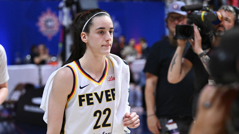 Caitlin Clark walks past camera during an Indiana Fever game