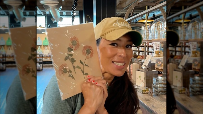 Joanna Gaines holding up a floral card