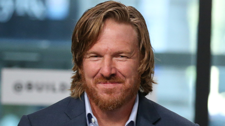 Chip Gaines pursing his lips while wearing a gray suit