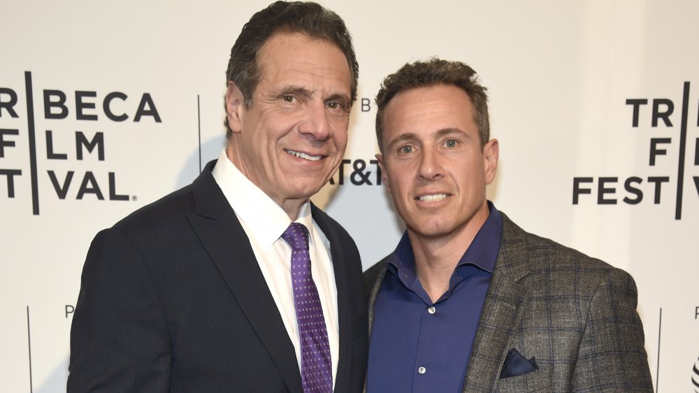 Chris and Andrew Cuomo both posing and smiling together