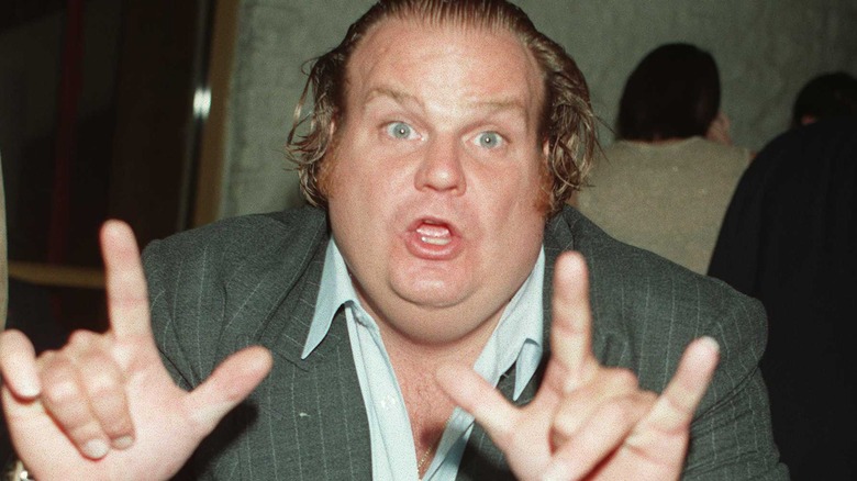 Chris Farley posing with hands in front of him