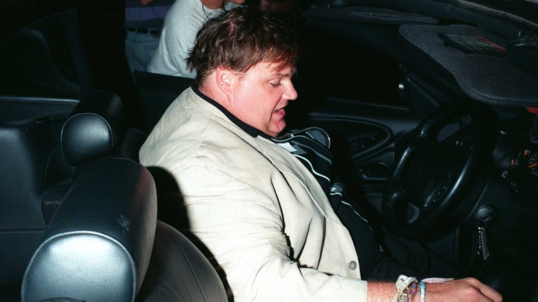 Chris Farley seated in car