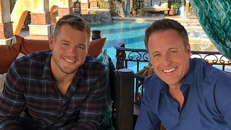 Colton Underwood and Chris Harrison by a pool