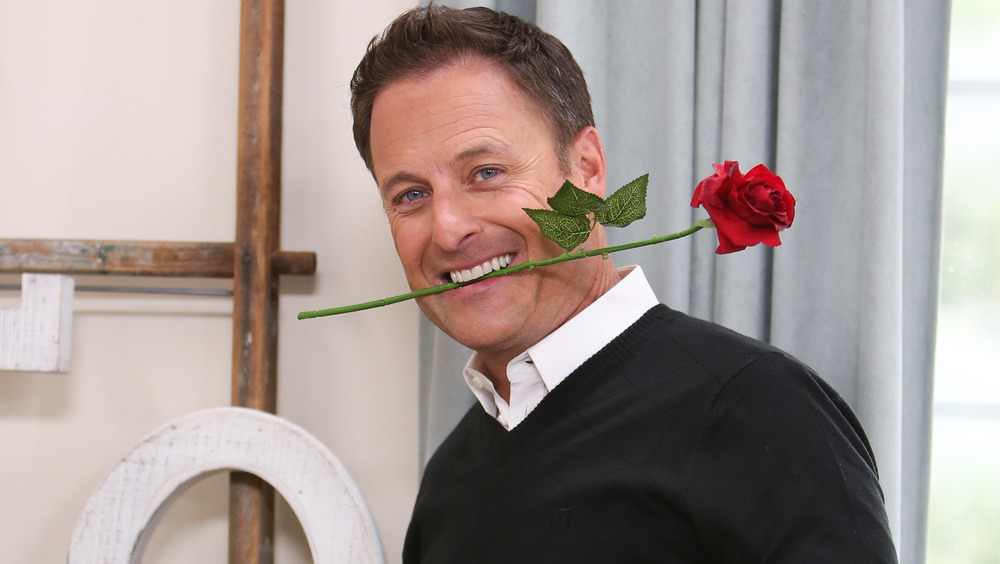 Chris Harrison holding a rose between his teeth