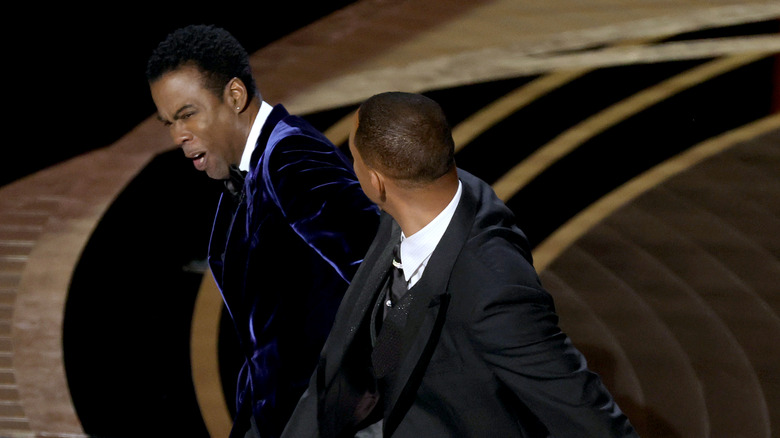 Will Smith slaps Chris Rock onstage at the 2022 Oscars