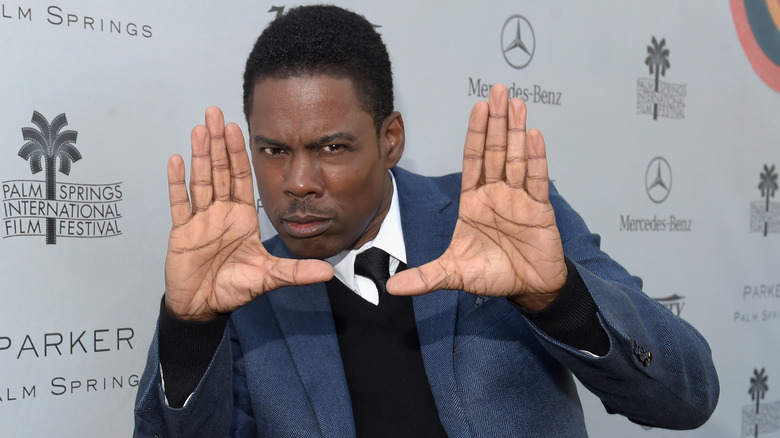 Chris Rock hands up red carpet 