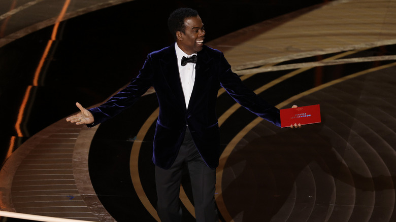 Chris Rock with arms out at Oscars