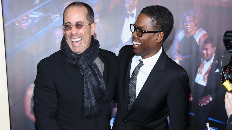 Chris Rock and Jerry Seinfeld hugging at a premiere in 2014.