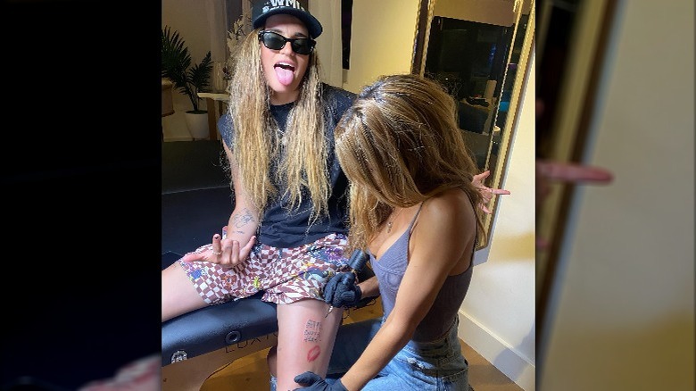 Chrishell Stause giving G Flip a tattoo