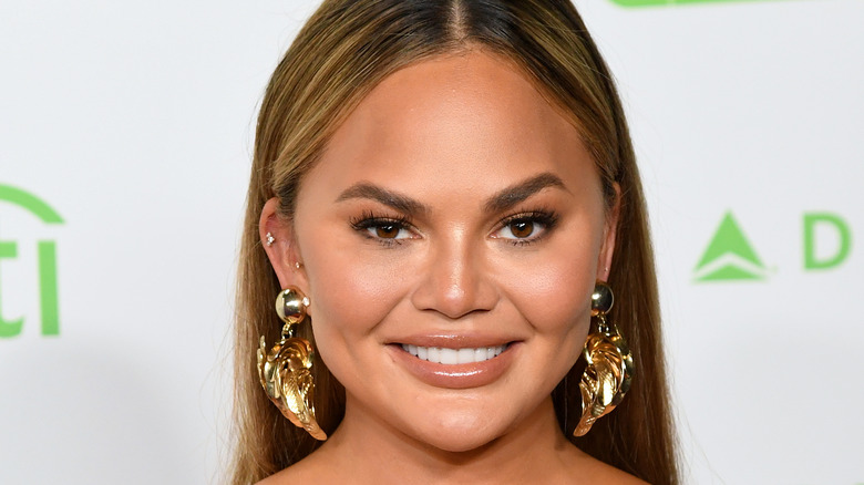 Chrissy Teigen wearing gold earrings