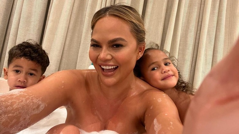 Chrissy Teigen in the bath with her kids