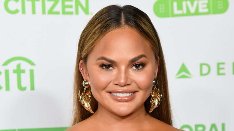 Chrissy Teigen smiling on red carpet