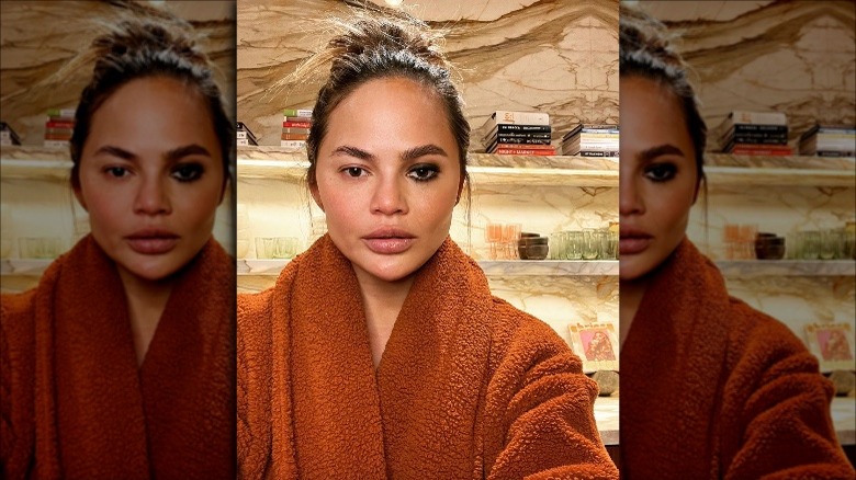 Chrissy Teigen wiearing makeup on one eye only