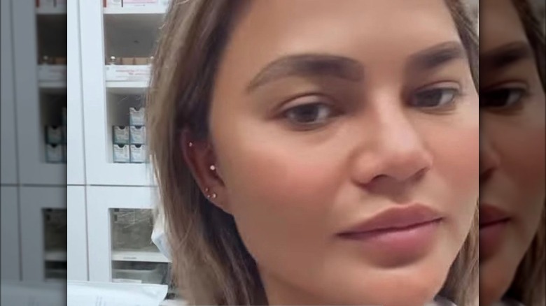 Chrissy Teigen posing for selfie with new eyebrows